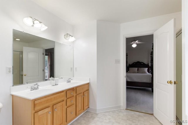 ensuite bathroom with tile patterned floors, connected bathroom, double vanity, and a sink