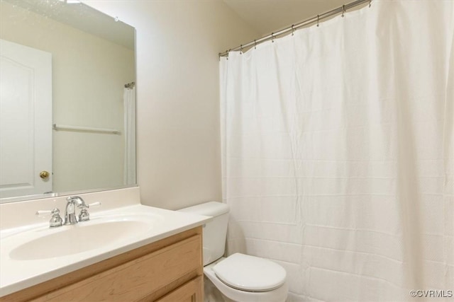full bathroom with toilet and vanity
