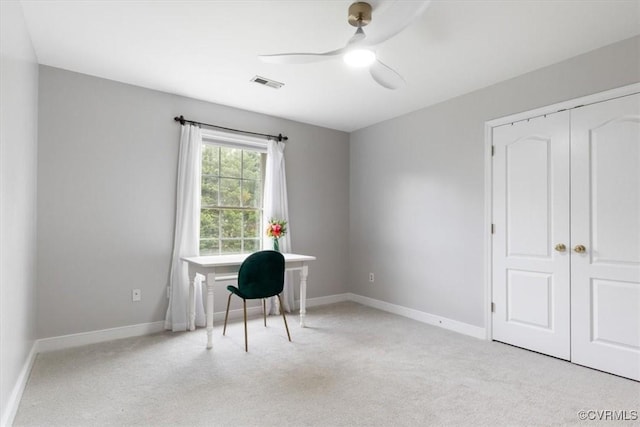 office featuring ceiling fan, light carpet, baseboards, and visible vents