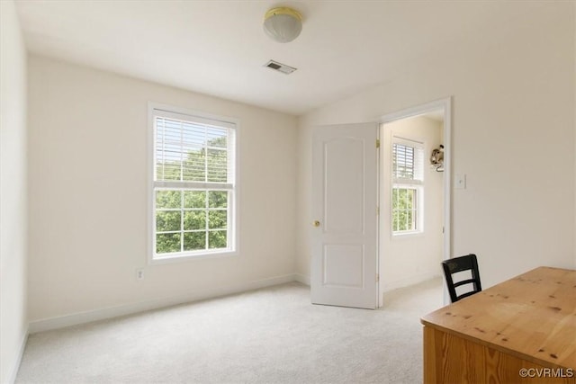 unfurnished office with light colored carpet, visible vents, and baseboards