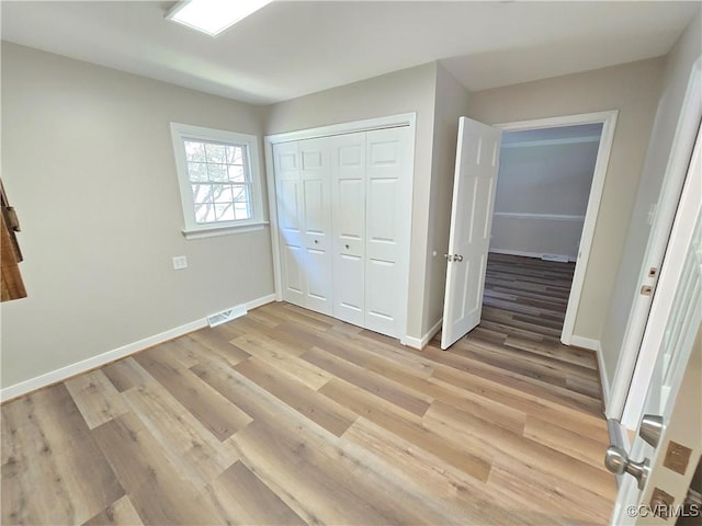 8600 Chester Forest Ln, North Chesterfield, VA 23237 - unfurnished bedroom featuring baseboards, a closet, light wood-style flooring, and visible vents