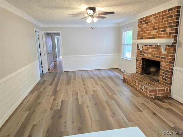 8600 Chester Forest Ln, North Chesterfield, VA 23237 - unfurnished living room featuring a textured ceiling, wainscoting, ceiling fan, and wood finished floors