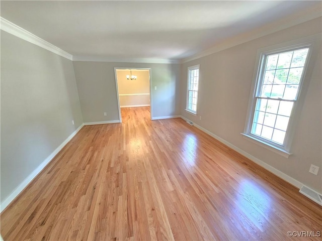 8600 Chester Forest Ln, North Chesterfield, VA 23237 - spare room with visible vents, ornamental molding, baseboards, a chandelier, and light wood finished floors