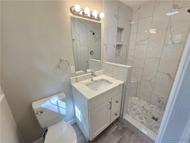 8600 Chester Forest Ln, North Chesterfield, VA 23237 - bathroom featuring wood finished floors, toilet, tiled shower, and vanity