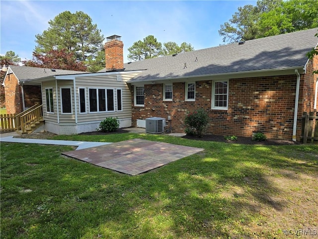 8600 Chester Forest Ln, North Chesterfield, VA 23237 - back of property with central air condition unit, brick siding, a chimney, and a shingled roof