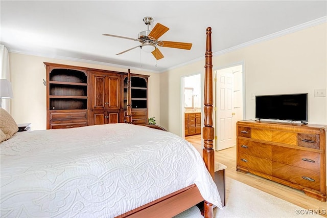 bedroom with crown molding, ceiling fan, light wood finished floors, and ensuite bath
