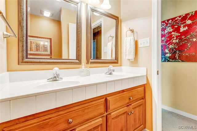 bathroom featuring double vanity and a sink