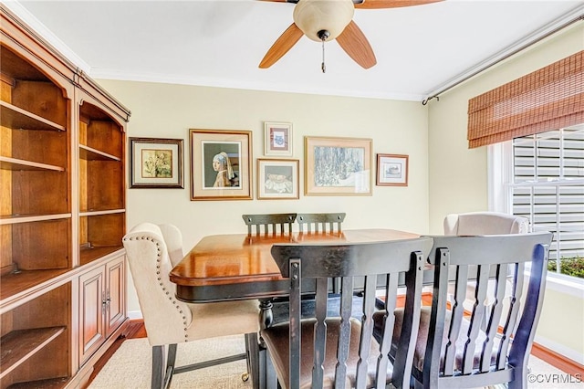 dining area featuring ornamental molding, a ceiling fan, and wood finished floors