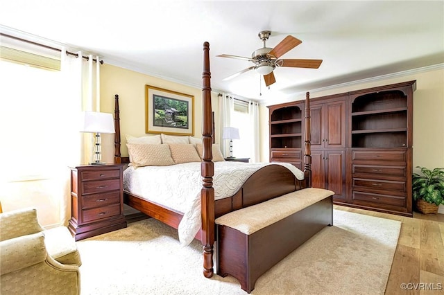bedroom featuring ceiling fan, ornamental molding, and light wood-style floors