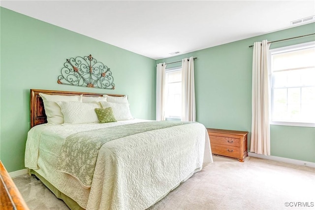 bedroom with visible vents, carpet, and baseboards