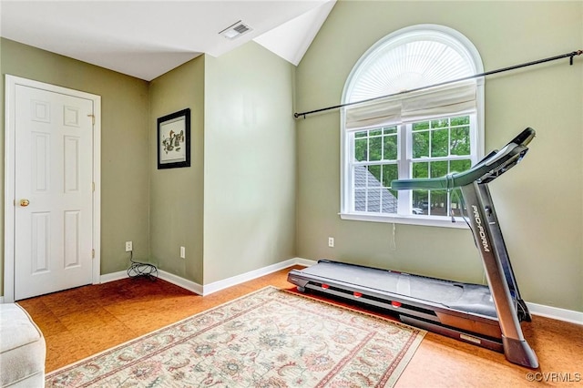 workout room with visible vents, baseboards, and vaulted ceiling