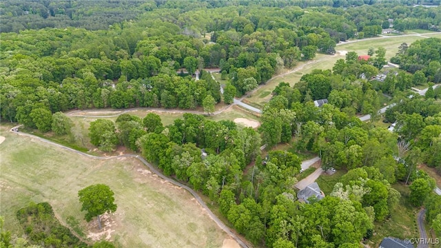 drone / aerial view featuring a forest view