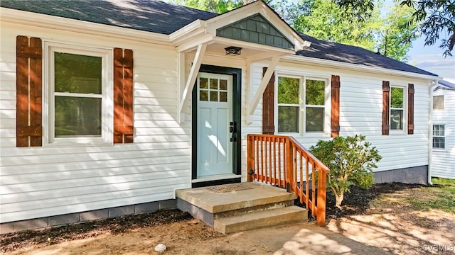 property entrance with a shingled roof