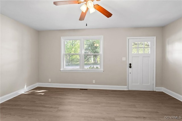 entryway with baseboards, ceiling fan, wood finished floors, and visible vents
