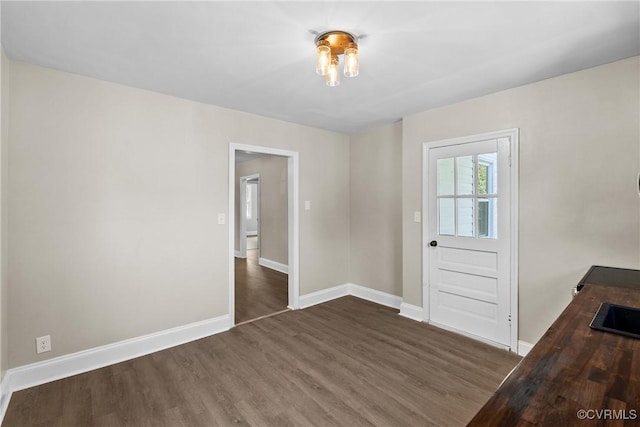 interior space with baseboards and wood finished floors