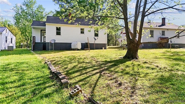 view of yard with central air condition unit and heating fuel