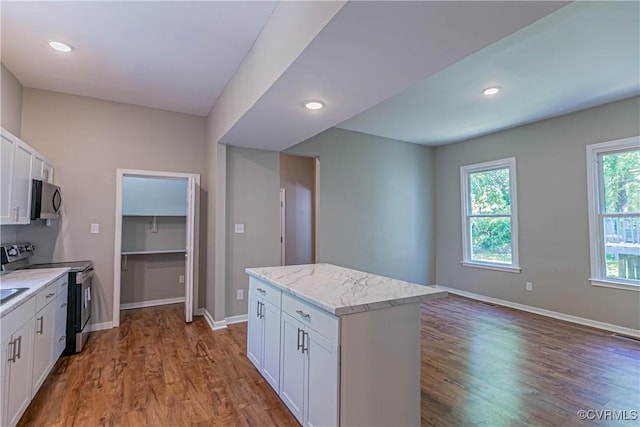 2008 2nd Ave, Richmond, VA 23222 - kitchen featuring baseboards, white cabinetry, appliances with stainless steel finishes, and wood finished floors