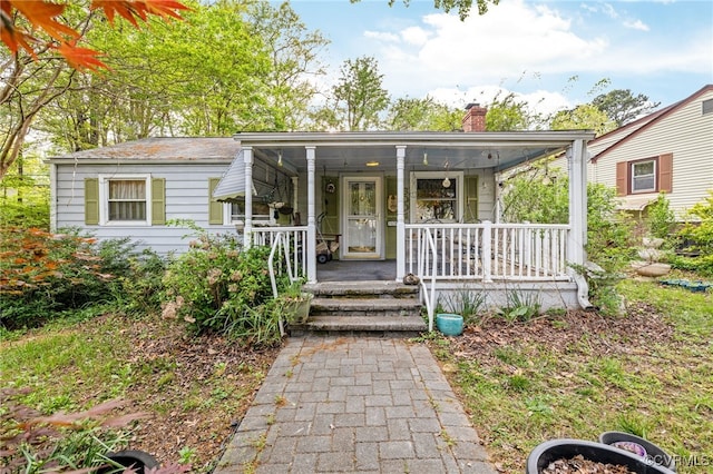 view of front of property featuring a porch and a chimney