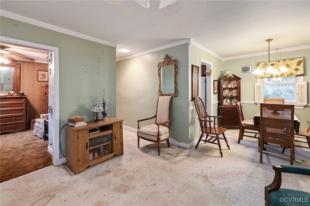 living area with carpet flooring, crown molding, baseboards, and ceiling fan