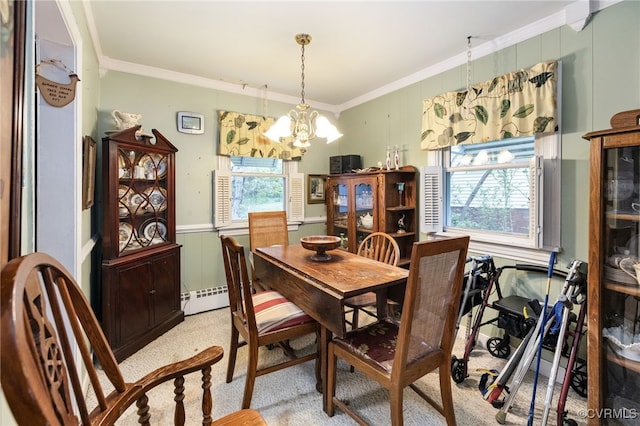 dining room featuring a wainscoted wall, ornamental molding, a baseboard heating unit, and a notable chandelier