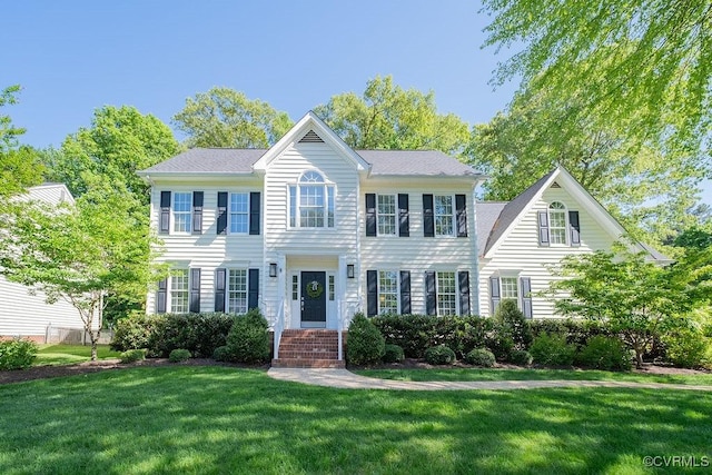 colonial-style house with a front yard