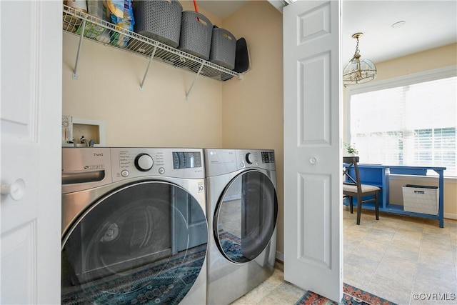 clothes washing area with laundry area and washer and dryer