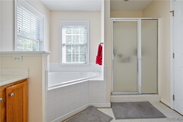 full bath with vanity, plenty of natural light, a stall shower, and a bath