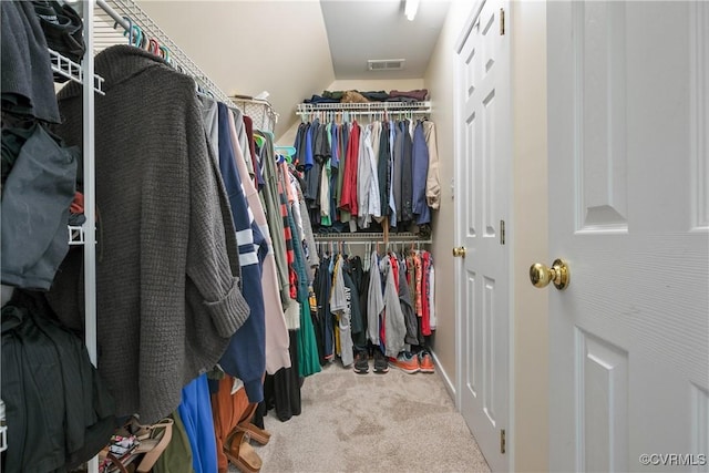 walk in closet with visible vents and carpet flooring