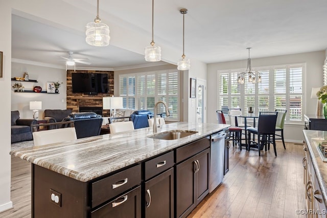 15501 Wolfboro Rd, Chesterfield, VA 23832 - kitchen with stainless steel dishwasher, dark brown cabinetry, a stone fireplace, a sink, and ceiling fan with notable chandelier