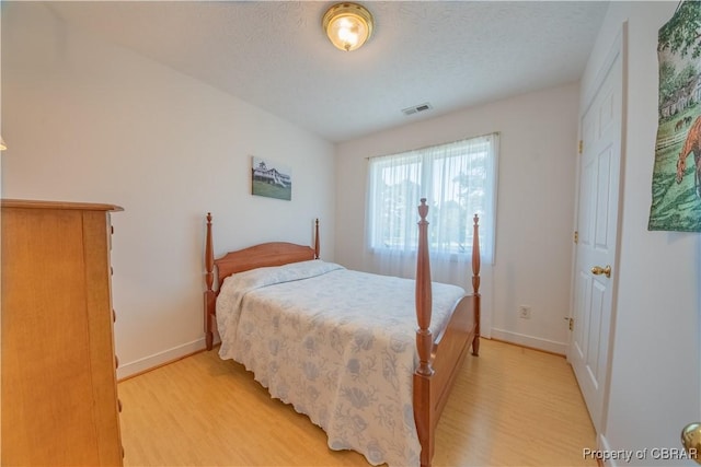 2000 Jenkins Neck Rd, Hayes, VA 23072 - bedroom featuring visible vents, a textured ceiling, baseboards, and light wood-type flooring