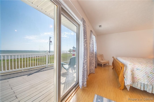 2000 Jenkins Neck Rd, Hayes, VA 23072 - bedroom with visible vents, light wood-style flooring, and access to outside