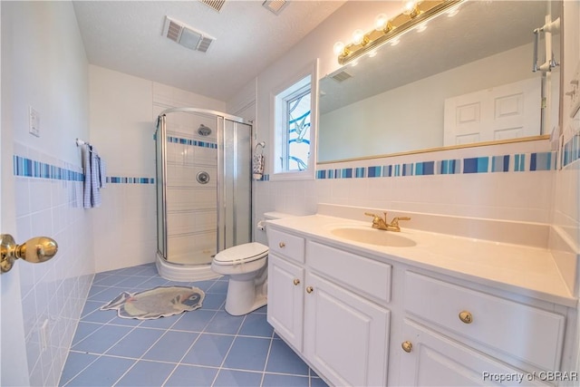 2000 Jenkins Neck Rd, Hayes, VA 23072 - full bath featuring vanity, tile patterned floors, tile walls, a shower stall, and visible vents