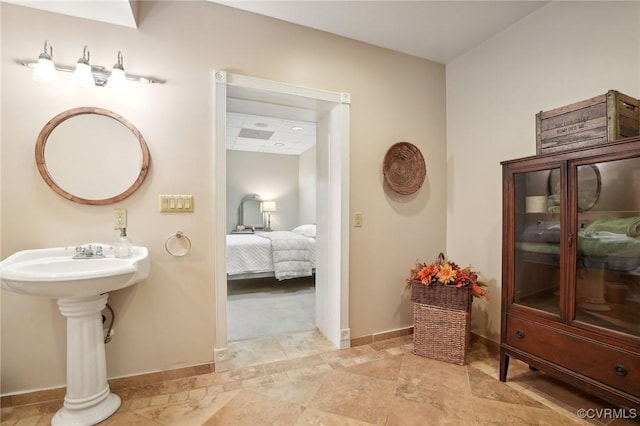 20145 Hunnicut Rd, Dinwiddie, VA 23803 - bathroom with baseboards, a sink, and connected bathroom