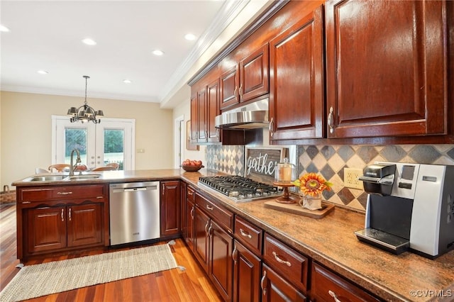 20145 Hunnicut Rd, Dinwiddie, VA 23803 - kitchen featuring appliances with stainless steel finishes, light wood-type flooring, a sink, ornamental molding, and under cabinet range hood