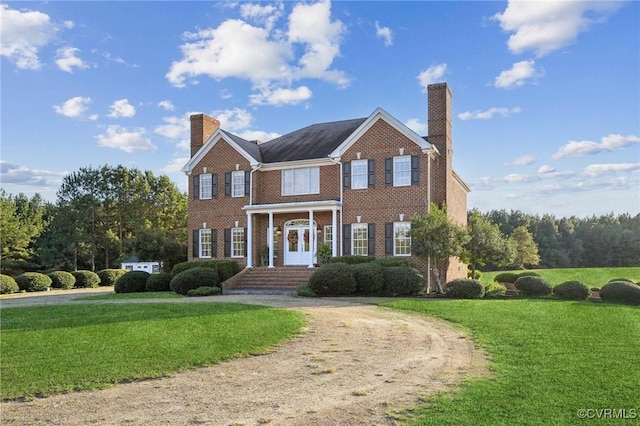 20145 Hunnicut Rd, Dinwiddie, VA 23803 - colonial inspired home with brick siding, a chimney, and a front lawn