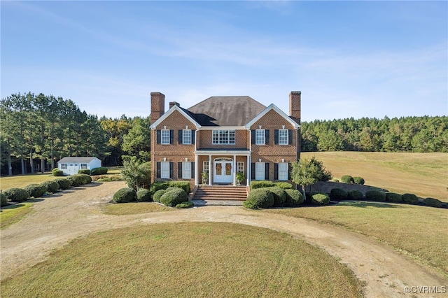 20145 Hunnicut Rd, Dinwiddie, VA 23803 - colonial-style house featuring brick siding, curved driveway, a chimney, and a front lawn