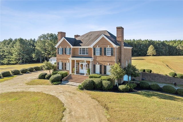 20145 Hunnicut Rd, Dinwiddie, VA 23803 - colonial inspired home featuring a chimney, a front lawn, and brick siding