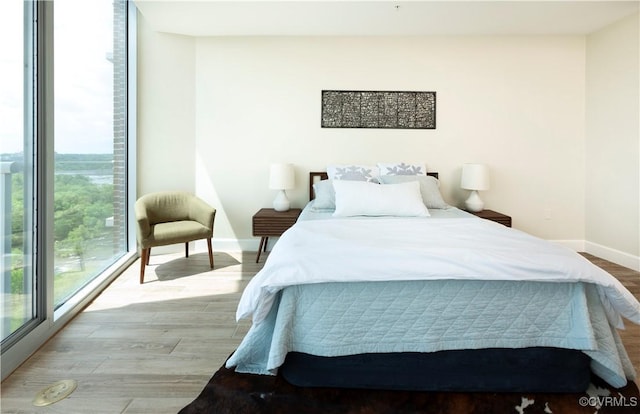 bedroom featuring baseboards and wood finished floors