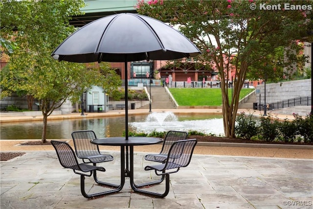 view of patio with a water view