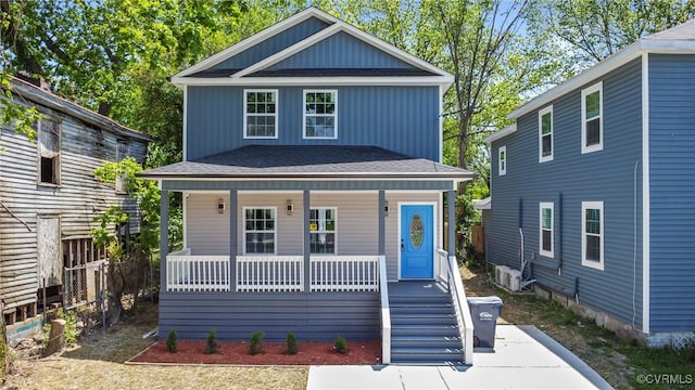 view of front of home featuring covered porch and a shingled roof