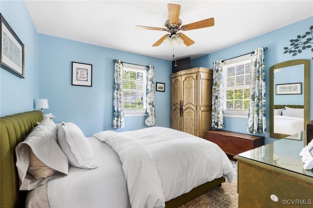 bedroom featuring a ceiling fan and multiple windows
