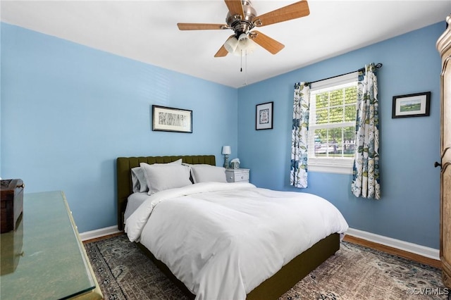 bedroom with baseboards, a ceiling fan, and wood finished floors