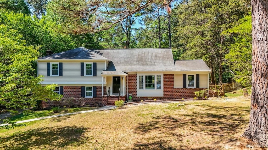 7403 Wyandotte Dr, Richmond, VA 23225 - tri-level home featuring fence, brick siding, and a front yard