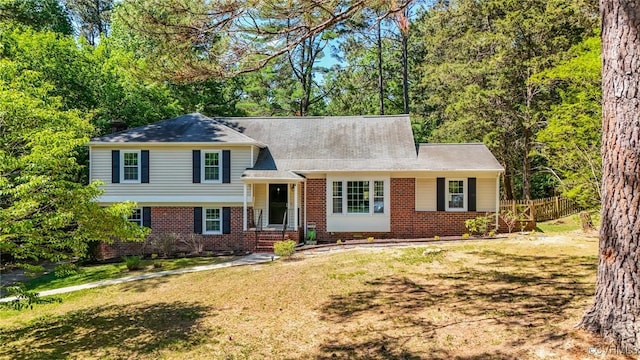 7403 Wyandotte Dr, Richmond, VA 23225 - tri-level home featuring fence, brick siding, and a front yard