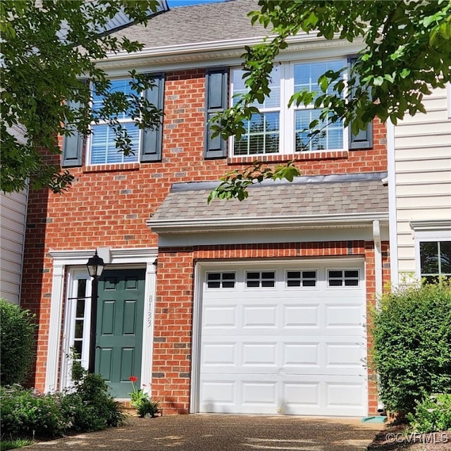 8133 Belton Cir, Mechanicsville, VA 23116 - view of front of house with a garage, brick siding, a shingled roof, and asphalt driveway