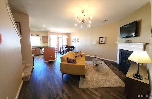 8133 Belton Cir, Mechanicsville, VA 23116 - living area with a chandelier, dark wood finished floors, a fireplace with flush hearth, baseboards, and recessed lighting