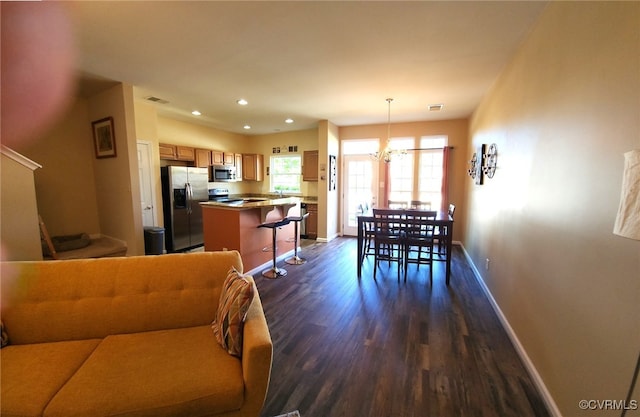 8133 Belton Cir, Mechanicsville, VA 23116 - living room with dark wood-style flooring, a chandelier, baseboards, recessed lighting, and stairway