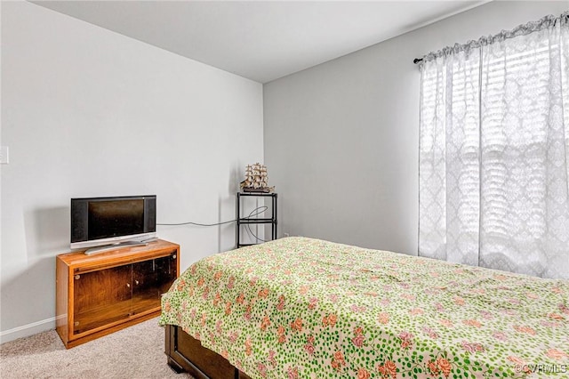 bedroom with carpet floors and baseboards