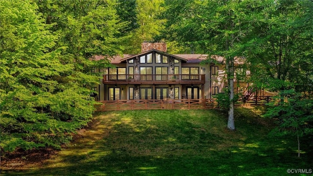 3640 Michaux Mill Dr, Powhatan, VA 23139 - back of property featuring french doors, a wooden deck, a lawn, a chimney, and a forest view