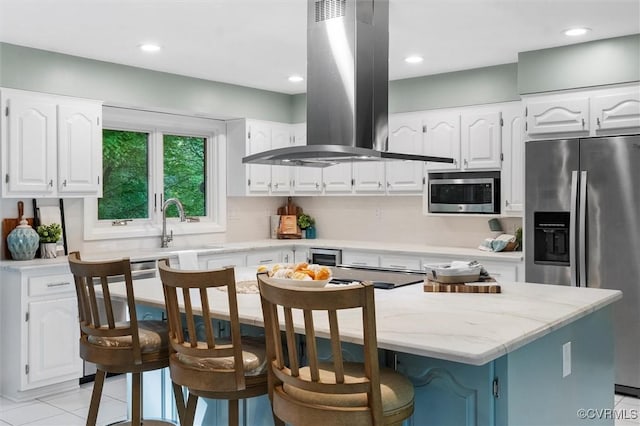 3640 Michaux Mill Dr, Powhatan, VA 23139 - kitchen with stainless steel appliances, island range hood, a center island, white cabinets, and light stone counters